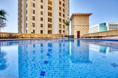 a large swimming pool in front of a building at Cozy 2 BD in Bahar JBR 24 floor in Dubai
