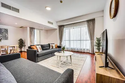 a living room with a couch and a table at Cozy 2 BD in Bahar JBR 24 floor in Dubai