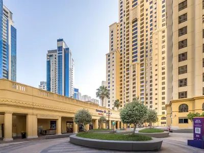 a street with tall buildings in a city at Cozy 2 BD in Bahar JBR 24 floor in Dubai