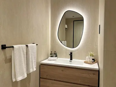 a bathroom with a sink with a mirror and towels at Family apartment next to the beach in Dubai