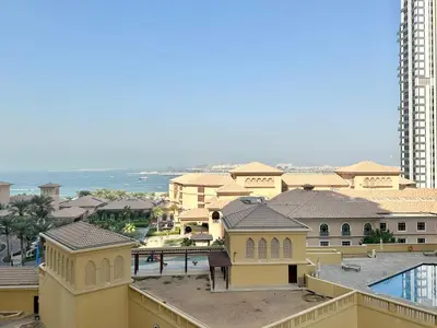 a view of a resort with a pool and buildings at Family apartment next to the beach in Dubai