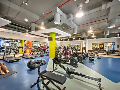 a gym with a lot of treadmills and machines at Silkhaus just furnished 1BDR in JBR near the beach in Dubai