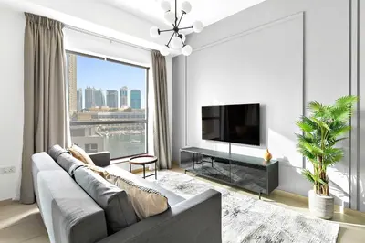 a living room with a couch and a large window at Silkhaus just furnished 1BDR in JBR near the beach in Dubai