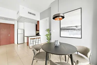 a dining room with a table and chairs at Silkhaus just furnished 1BDR in JBR near the beach in Dubai