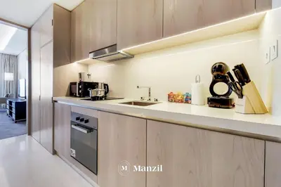 a kitchen with a sink and a counter top at Manzil - Studio Apartment with Aura Pool & Sea View at The Palm Tower in Palm Jumeirah in Dubai