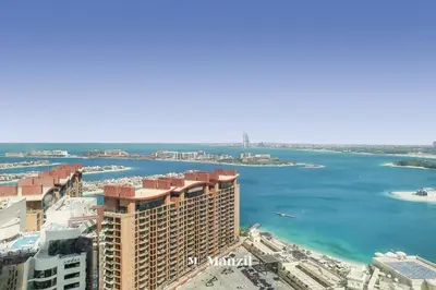 an aerial view of a city and the ocean at Manzil - Studio Apartment with Aura Pool & Sea View at The Palm Tower in Palm Jumeirah in Dubai