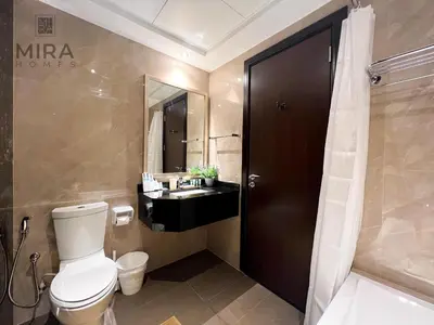 a bathroom with a toilet and a sink at Mira Holiday Homes - Serviced apartment in Downtown in Dubai
