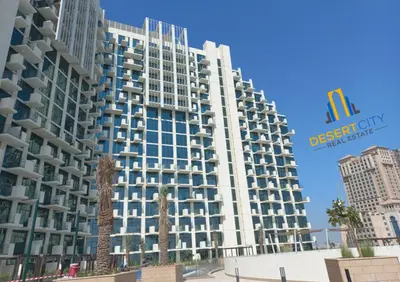 a tall building with a sign on the side of it at 2 Bed in Azzizi Farhad with Burj Khalifa view by Desert City Stays in Dubai