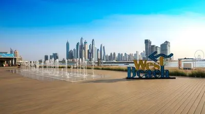 a bench with water fountains in front of a city at Ultra Luxury Palm - Free 5-star Beach Resorts Access in Dubai