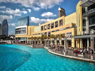 a shopping mall with a large pool of water at Cosmos Living 1 Bedroom Paramount Hotels in Dubai
