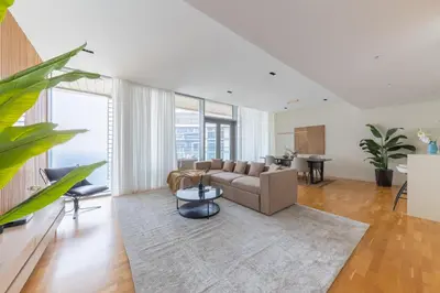 a living room with a couch and a table at Welcome Home - Bluewaters brand new 2-bedroom in Dubai