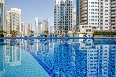 a swimming pool in a city with tall buildings at Canal View apartment in Marina in Dubai