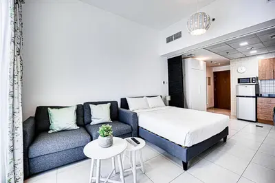 a living room with a bed and a couch at Canal View apartment in Marina in Dubai