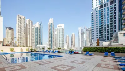 a pool in the middle of a city with tall buildings at Canal View apartment in Marina in Dubai