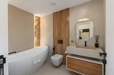 a bathroom with a tub and a toilet and a sink at Sunrise Bay 2, Emaar Beachfront - Mint Stay in Dubai