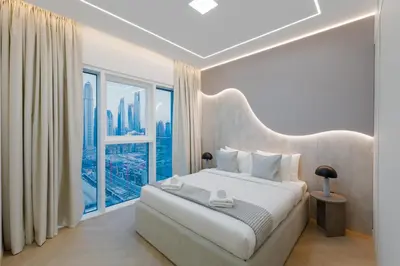 a bedroom with a large bed and a large window at Sunrise Bay 2, Emaar Beachfront - Mint Stay in Dubai