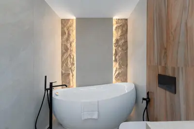 a bathroom with a white bath tub in a room at Sunrise Bay 2, Emaar Beachfront - Mint Stay in Dubai