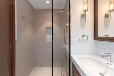 a bathroom with a shower and a sink at Sunrise Bay 2, Emaar Beachfront - Mint Stay in Dubai