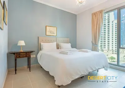 a bedroom with a large bed and a window at 2 Bed Room in Attessa Tower, Dubai Marina by Desert City Stays in Dubai
