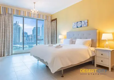 a bedroom with a large bed and a large window at 2 Bed Room in Attessa Tower, Dubai Marina by Desert City Stays in Dubai