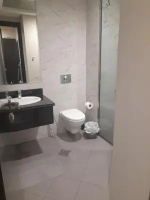 a bathroom with a toilet and a sink and a shower at a chilled place in Dubai