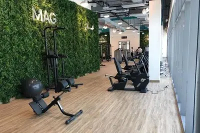 a gym with rows of exercise bikes and a green wall at a chilled place in Dubai