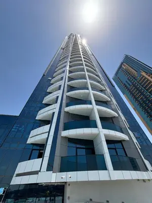 a tall building with the sun in the sky at O2R26- Elegant Studio in O2 Residential Tower in Dubai