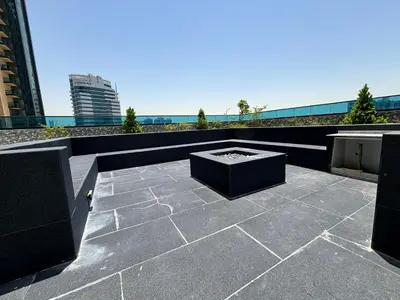 a patio with a fire pit on top of a building at O2R26- Elegant Studio in O2 Residential Tower in Dubai