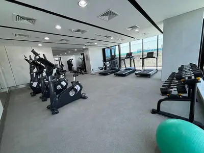 a gym with several treadmills and exercise bikes at O2R26- Elegant Studio in O2 Residential Tower in Dubai