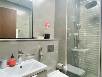 a bathroom with a shower and a sink and a toilet at O2R26- Elegant Studio in O2 Residential Tower in Dubai