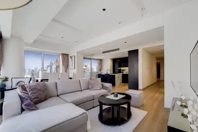 a living room with a couch and a table at 5-Star Address Dubai Marina Mall Stunning Marina Views 3-Bedroom in Dubai
