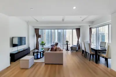 a living room with a couch and a tv and a table at 5-Star Address Dubai Marina Mall Stunning Marina Views 3-Bedroom in Dubai
