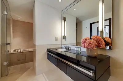 a bathroom with a sink and a mirror at 5-Star Address Dubai Marina Mall Stunning Marina Views 3-Bedroom in Dubai