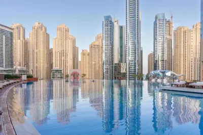 a large pool in a city with tall buildings at 5-Star Address Dubai Marina Mall Stunning Marina Views 3-Bedroom in Dubai