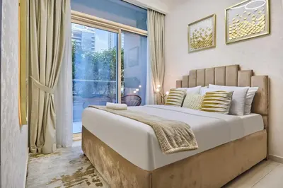 a bedroom with a large bed and a large window at Elegant 1BR in Vera Minutes from Dubai Mall in Dubai