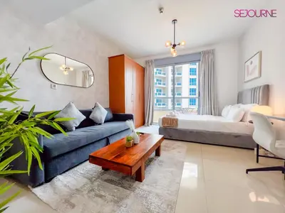 a living room with a couch and a bed at LS10-Well Designed Studio In Lake Side Tower A in Dubai