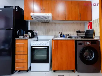 a kitchen with a stove and a washing machine at LS10-Well Designed Studio In Lake Side Tower A in Dubai