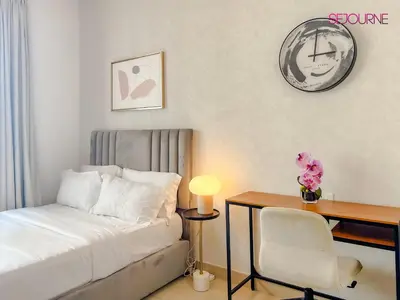 a bedroom with a bed and a desk and a chair at LS10-Well Designed Studio In Lake Side Tower A in Dubai
