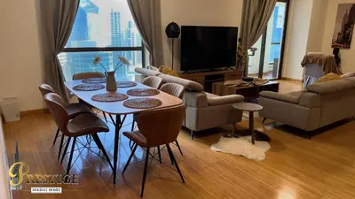 a living room with a table and chairs and a television at Prestige holiday home Bed space in Dubai
