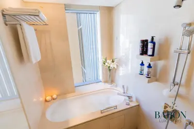a bathroom with a bath tub and a window at The Timeless in Dubai