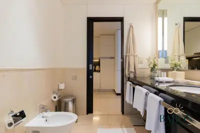 a bathroom with a sink and a tub and a toilet at The Timeless in Dubai