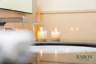 two candles sitting on a table with a mirror at The Timeless in Dubai