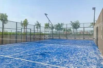 a tennis court with a net on it at Frank Porter - Collective Tower 1 in Dubai