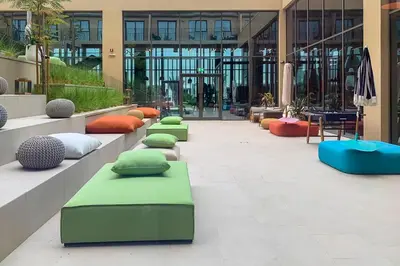 a lobby with many pillows and tables in a building at Frank Porter - Collective Tower 1 in Dubai