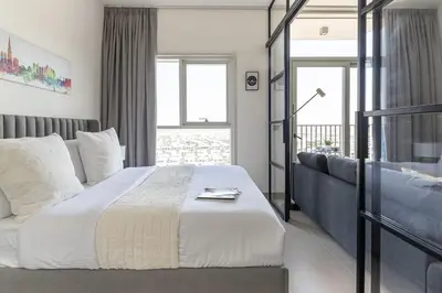 a bedroom with a large bed and a couch at Frank Porter - Collective Tower 1 in Dubai