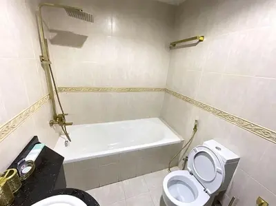 a bathroom with a toilet and a bath tub at Dubai Marina Gem - Elite Residences 1BHK Retreat 4501 in Dubai
