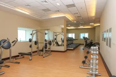 a gym with several treadmills and exercise machines at Dubai Marina Gem - Elite Residences 1BHK Retreat 4501 in Dubai