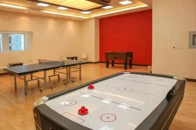 a room with two ping pong tables and a ping pong ball at Dubai Marina Gem - Elite Residences 1BHK Retreat 4501 in Dubai