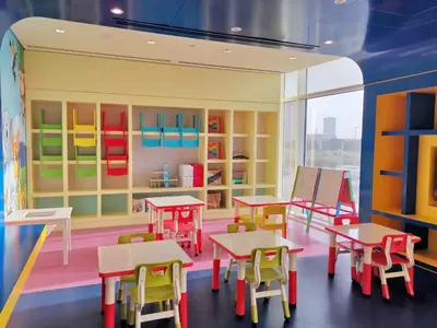a room with tables and chairs in a toy store at Vacay lettings - Upgraded studio at Damac tower JVC in Dubai
