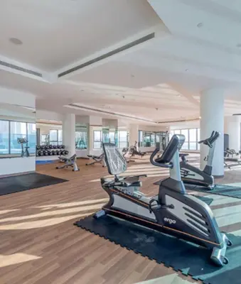 a gym with treadmills and elliptical machines at Elegant 2BR view with rooftop pool The Bay in Dubai